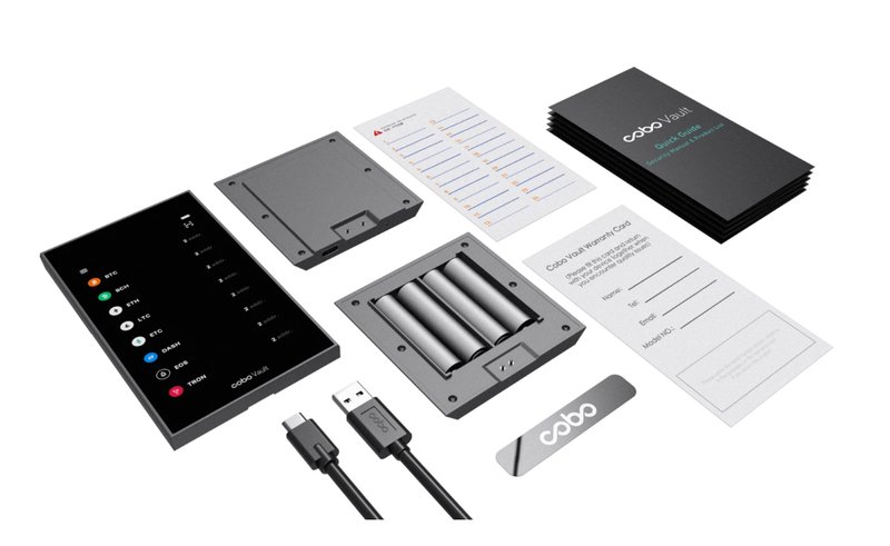 A Keystone hardware wallet package includes a digital screen device, backup cards, battery holder, USB cable, and user manuals laid out on a white background.