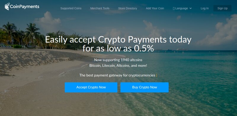 Screenshot of the CoinPayments homepage featuring a beach background. Text advertises accepting crypto payments for as low as 0.5%, supporting 1940 altcoins through their leading crypto payment gateways. Buttons read "Accept Crypto Now" and "Buy Crypto Now".