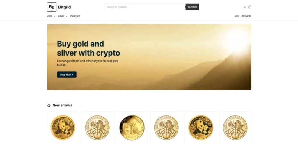 Website homepage of Bitgold showing a banner with mountains and text promoting buying gold and silver with cryptocurrency. Below are images of five gold coins under the "New arrivals" section.