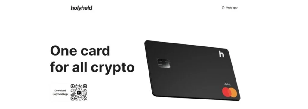 An advertisement displays a Holyheld crypto debit card. Text reads "One card for all crypto" with a QR code for downloading the Holyheld app. The card proudly features the Mastercard logo, emphasizing it's your ultimate Crypto Debit Card solution.